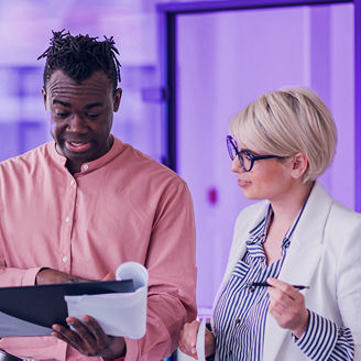 A group of people at the office talking and laughing