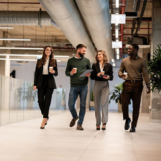 A group of people walking with a coffee cup in their hand