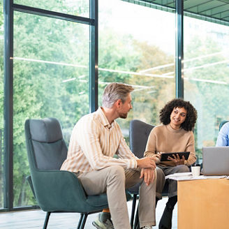A group of people sitting in chairs around a coffee table.