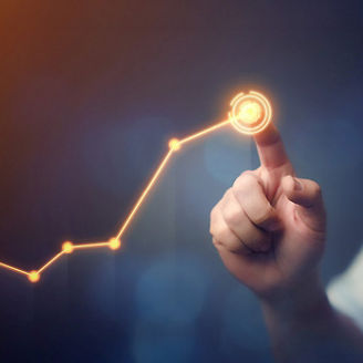 Business professional in a shirt pointing at a graph showing a rising growth curve.