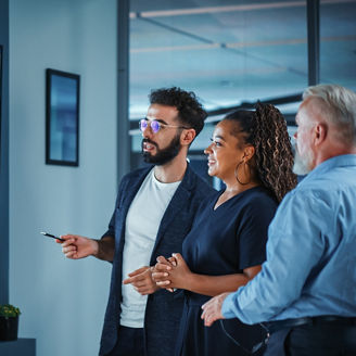 CFOs interacting in front of data screen