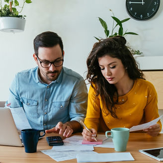 Two people working together on a laptop