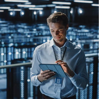 Man in server room on tablet