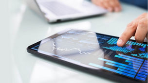 hand on tablet with statistics app