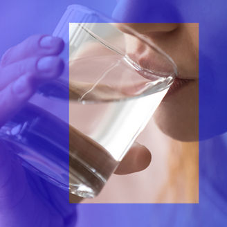 A woman drinking water in a glass