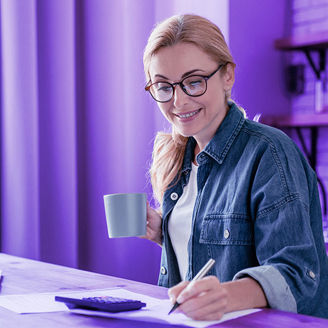 Woman taking notes while working at her desk