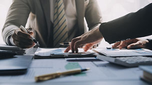 Deux personnes travaillant à un bureau, l'une d'elles montrant quelque chose sur un papier