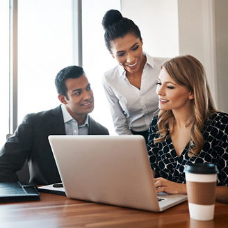 Three people sitting at a table in a meeting