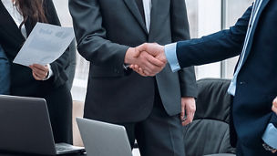 A photo of two men shaking hands