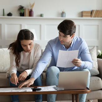 Two concentrated people looking at files
