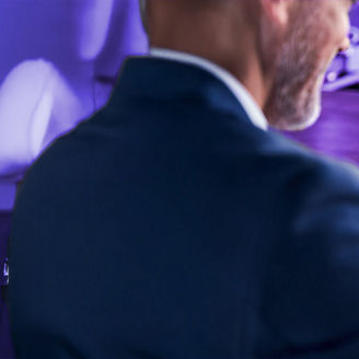 Man looking at stats and graphs on laptop