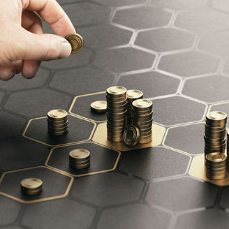 Stacks of coins on a dark background.