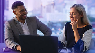 Two collegues working on a laptop