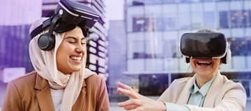 Two colleagues with VR headset laughing