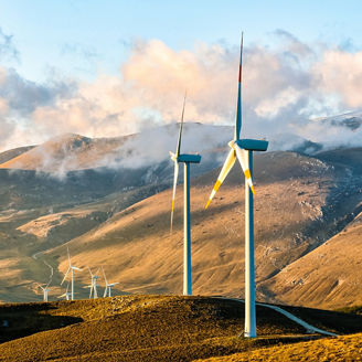 Two engineers looking at laptop over solar panels