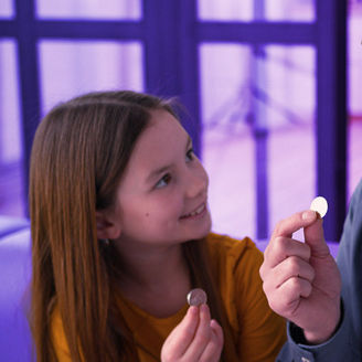 a father and his child with a coin in their hands