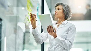 businesswoman writing on white board