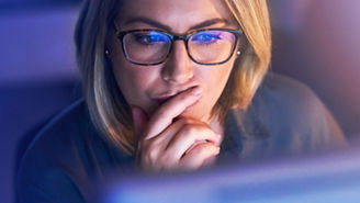 Looking carefully over financial performance on computer