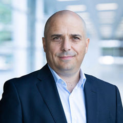 Blurred abstract background interior view looking out toward to empty office lobby and entrance doors and glass curtain wall with frame - blue white balance processing style