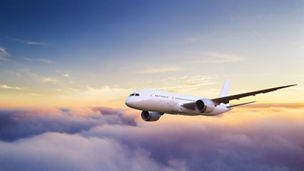 Huge two-storey passengers commercial airplane flying above clouds in sunset light. Concept of fast travel, holidays and business.