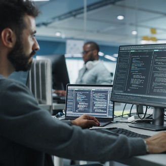 Diverse Office: Enthusiastic White IT Programmer Working on Desktop Computer. Male Specialist Creating Innovative Software. Engineer Developing App, Program, Video Game. Writing Code in Terminal