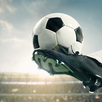 Banner. Soccer athlete performing high kick, striking soccer ball mid-air with precision, powerful motion captured against stadium backdrop. Concept of sport championship, match, tournament. Ad