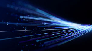 Futuristic blue and cyan light streaks curve across a dark background toward a bright focal point, creating a dynamic concept of high-speed data flow, connectivity, and digital technology.
