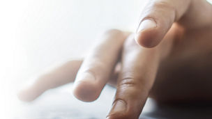 Hand typing on keyboard