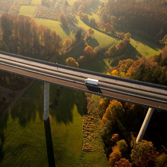 Aerial view of lorry on motorway bridge