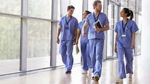 two people walking in nurse clothing