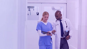 Healthcare professionals walking together in a hospital.