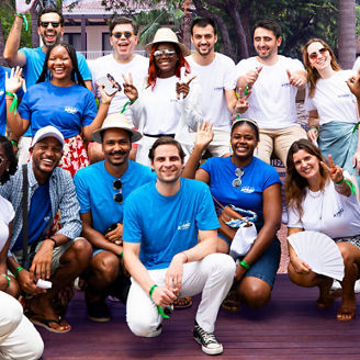 Young people outdoors in a team-building initiative, chatting and smiling