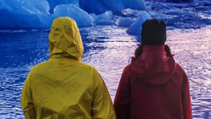 two people standing in front of lake