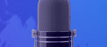Podcast microphone in front of world map