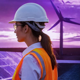 Construction worker at solar panels and windmills