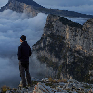 man looking over the cloud on top of a mountain