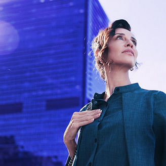 A woman looking up at the sky with a bulging behind