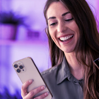 Girl smiling while looking at phone