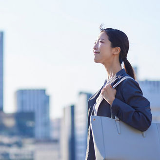 Japanese woman in front of large buildings