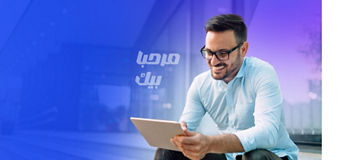 young man smiling while scolling digital screen.