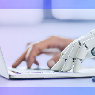 A robot hand working on a computer