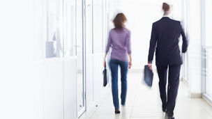 People walking in office hallway