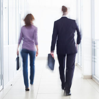 People walking in office hallway