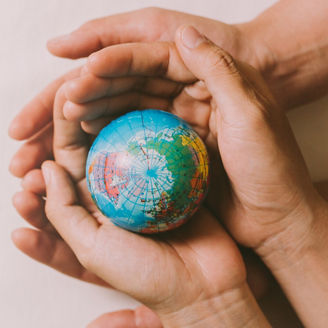 Two hands holding a globe