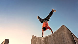 Man doing a handstand on concrete blocks
