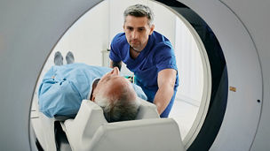 A nurse helps a patient in MRI machine to test