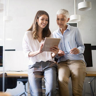 Women working together, learning on a tablet