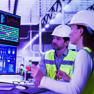 Worker in front of the control panel