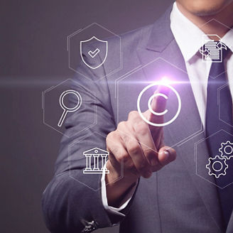 A man, wearing a suit, points to a virtual screen displaying floating icons representing various industries