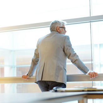 Mature man looking at the window